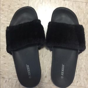 Black fluffy slides.